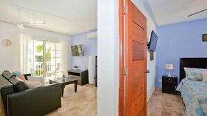 Ein Zimmer mit einem Bett, einem Fernseher, einem Nachttisch und einem Fenster mit Vorhängen.