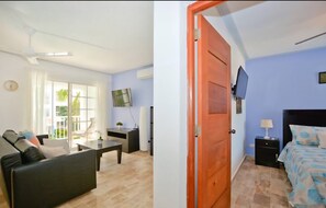 A room with a bed, a TV, a nightstand, and a window with curtains. - 2-bedroom 2nd level condo in El Cortecito (El Cortecito)