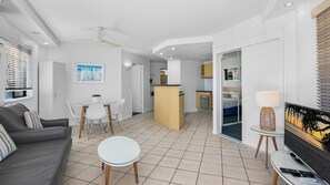 A modern apartment with a living room, dining area, kitchen, and bedroom. - Mooloolaba Resort next to beach 2BR apartment (Mooloolaba)