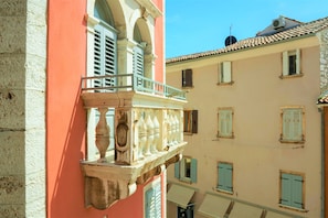 A multi-story building with balconies, a stone facade, and a tiled roof. - Casa Luigi Studio 2 – Unique View and Prime Location (Rovinj)