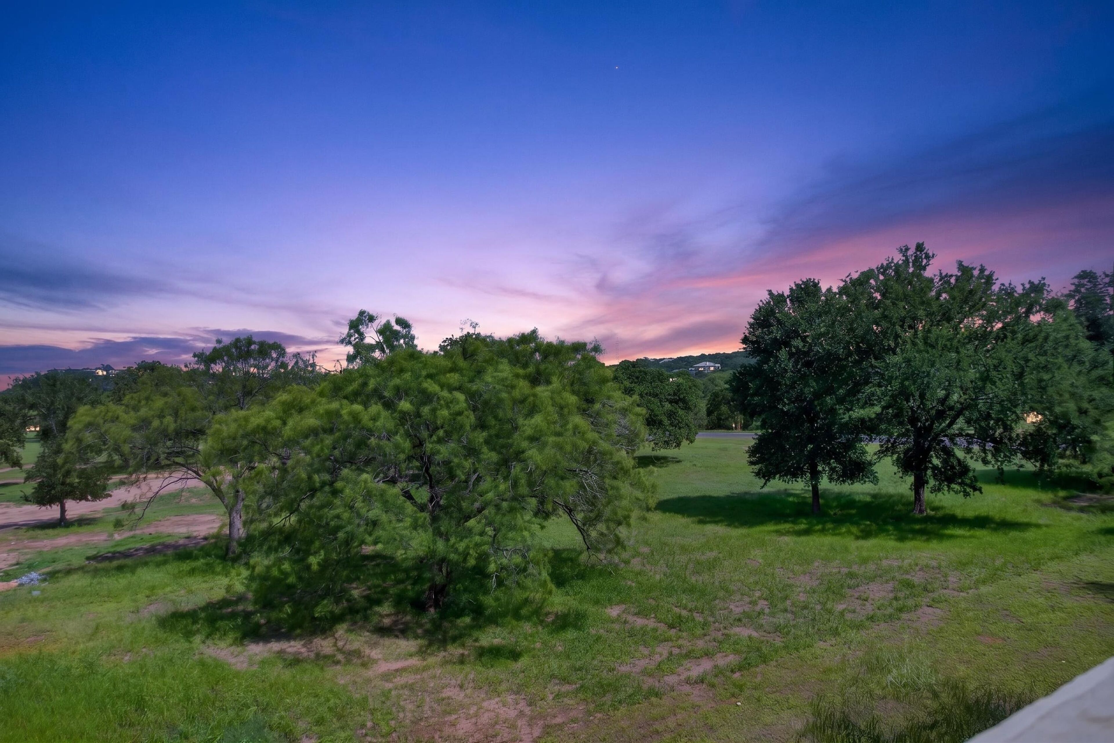 A natural landscape with trees and a clear sky.