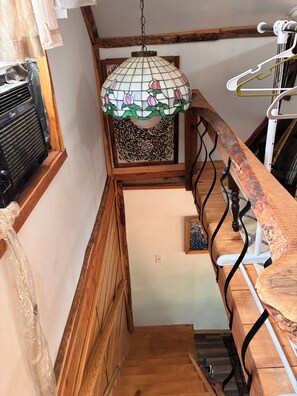 A wooden staircase with a stained glass lamp, a radiator, and a white wall. - Cozy 1-bedroom cabin in marvelous Tazewell (Tazewell)