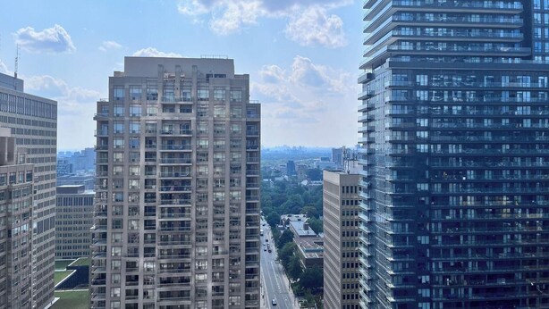 A high-rise building with multiple floors, large windows, and a clear view of the surrounding cityscape. - Heat of Downtown Walking to TTC Subway&Queenspark&UniversityOfToronto in 3 mins! (Toronto)