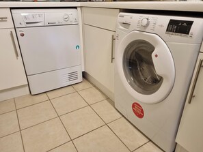 A compact kitchen with a dishwasher and a front-loading washing machine. - 11 Thurlestone Rock (Kingsbridge)
