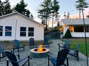 A house with a fire pit and outdoor seating.