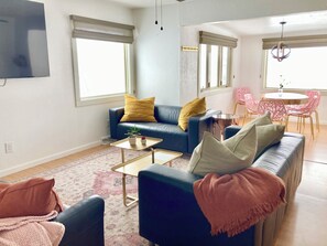 A modern living room with a blue sofa, a coffee table, and a patterned rug. - the Sheep Shack #6204 - Private Hot Tub - Mountain Views - 3 bedrooms - Fire Pit (Estes Park)
