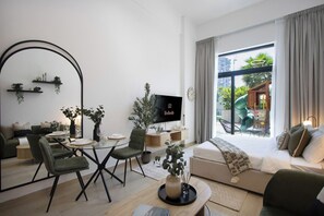 Uma sala de estar moderna com sofá, mesa de jantar, cadeiras, TV e varanda com escorrega.