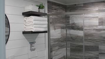 Shower, hair dryer, towels, shampoo