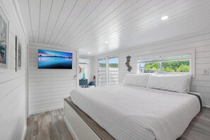 A bedroom with a large bed, a TV, a window with a view, and a 'RELAX' sign. - Four Suns - Lake Front Floating House Retreat (Russell Springs)