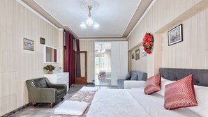 A hotel room with a bed, two sofas, a chair, a mirror, and a view of the outside. - Home OF Mestre (Venezia)