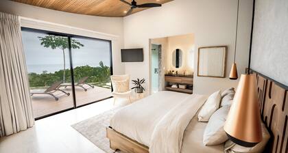Modern adults-only villa with private plunge pool and panoramic ocean-to-mountain views.