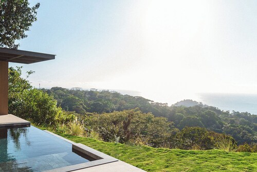 Modern adults-only villa with private plunge pool and panoramic ocean-to-mountain views.