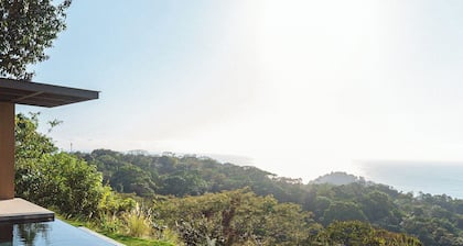 Modern adults-only villa with private plunge pool and panoramic ocean-to-mountain views.