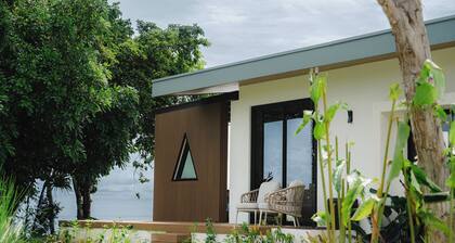 Modern adults-only villa with private plunge pool and panoramic ocean-to-mountain views.
