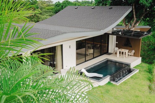 Modern adults-only villa with private plunge pool and panoramic ocean-to-mountain views.