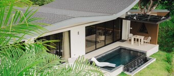 Modern adults-only villa with private plunge pool and panoramic ocean-to-mountain views.