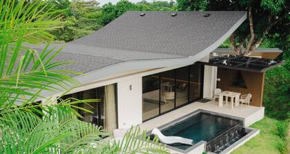 Modern adults-only villa with private plunge pool and panoramic ocean-to-mountain views.