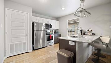 Fridge, stovetop, dishwasher, coffee/tea maker