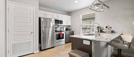 Fridge, stovetop, dishwasher, coffee/tea maker