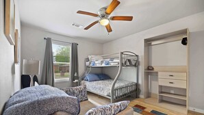 A bedroom with a bunk bed, a ceiling fan, a desk, and a window with curtains. - Cozy Stay_2Bedrooms_Work Space_Near Attractions (Fort Smith)