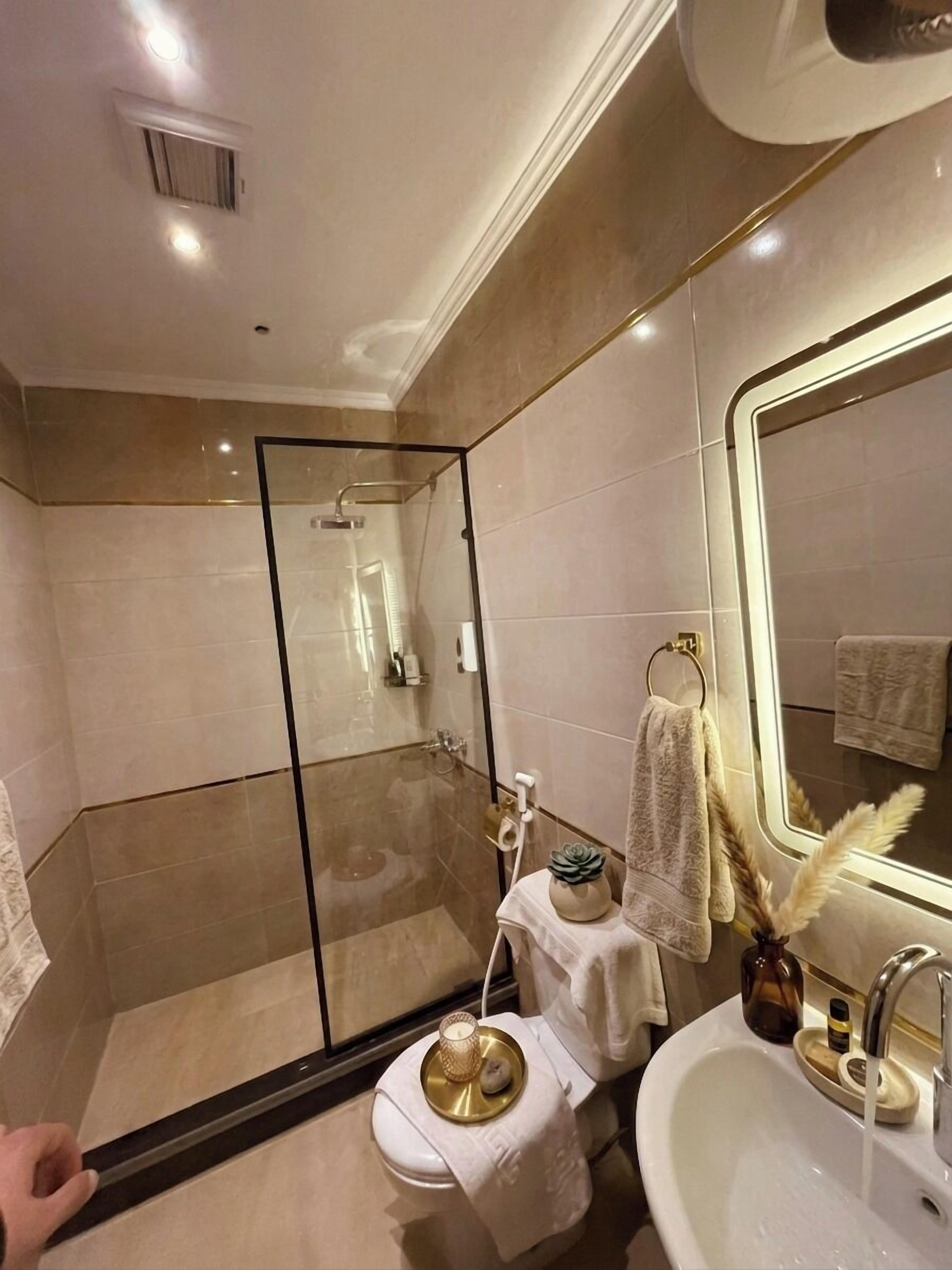 Shower, hair dryer, slippers, towels