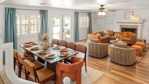 A dining area with a wooden table set for four, surrounded by brown chairs. - Desert Daze • A Fun-Filled 5BR Retreat • Sleeps 12 (Mesa)