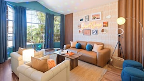 A modern living room with a sofa, armchairs, a coffee table, and a lamp. - Desert Daze • A Fun-Filled 5BR Retreat • Sleeps 12 (Mesa)