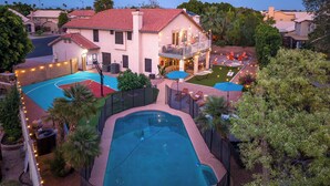 A residential property with a swimming pool, tennis courts, and a patio area with outdoor seating. - Desert Daze • A Fun-Filled 5BR Retreat • Sleeps 12 (Mesa)