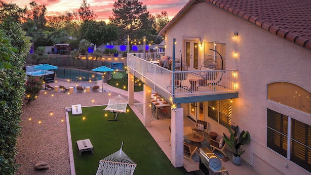 A house with a pool, outdoor seating, and string lights. - Desert Daze • A Fun-Filled 5BR Retreat • Sleeps 12 (Mesa)
