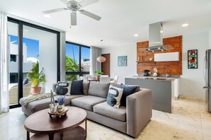 Ein modernes Wohnzimmer mit Sofa, Couchtisch und Blick ins Freie.