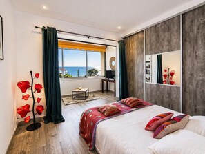 A modern bedroom with a large bed, a desk, and a view of the sea. - REF ESTEREL BY PALMES D OR PROPERTIES (Mandelieu-la-Napoule)