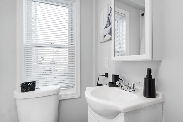 Shower, hair dryer, towels, toilet paper