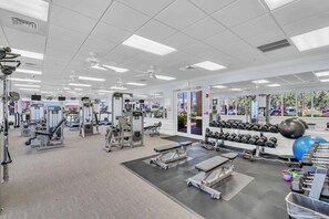 A gym with various exercise equipment, mirrors, and a view of the outside. - Luxury Palmer Ranch Home-Siesta Key, Pickleball & Pool (Sarasota)