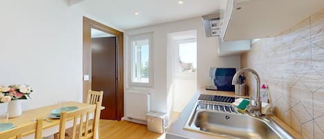 Fridge, microwave, coffee/tea maker, cookware/dishes/utensils
