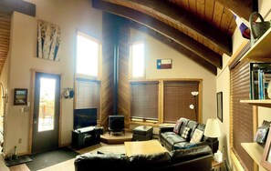 A cozy living room with a fireplace, a sofa, a coffee table, and a TV. - Sleeps 14, 3 Bedroom Home, Large Private Deck, on (Crested Butte)