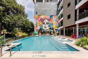 A swimming pool with a mural, a 4 ft no diving sign, and a building with balconies. - Riverwalk Balcony Views Walk to Pearl Pool Parking Option 2 Free Parking (San Antonio)