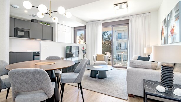 Un appartement moderne comprenant un coin repas, une cuisine et un salon.