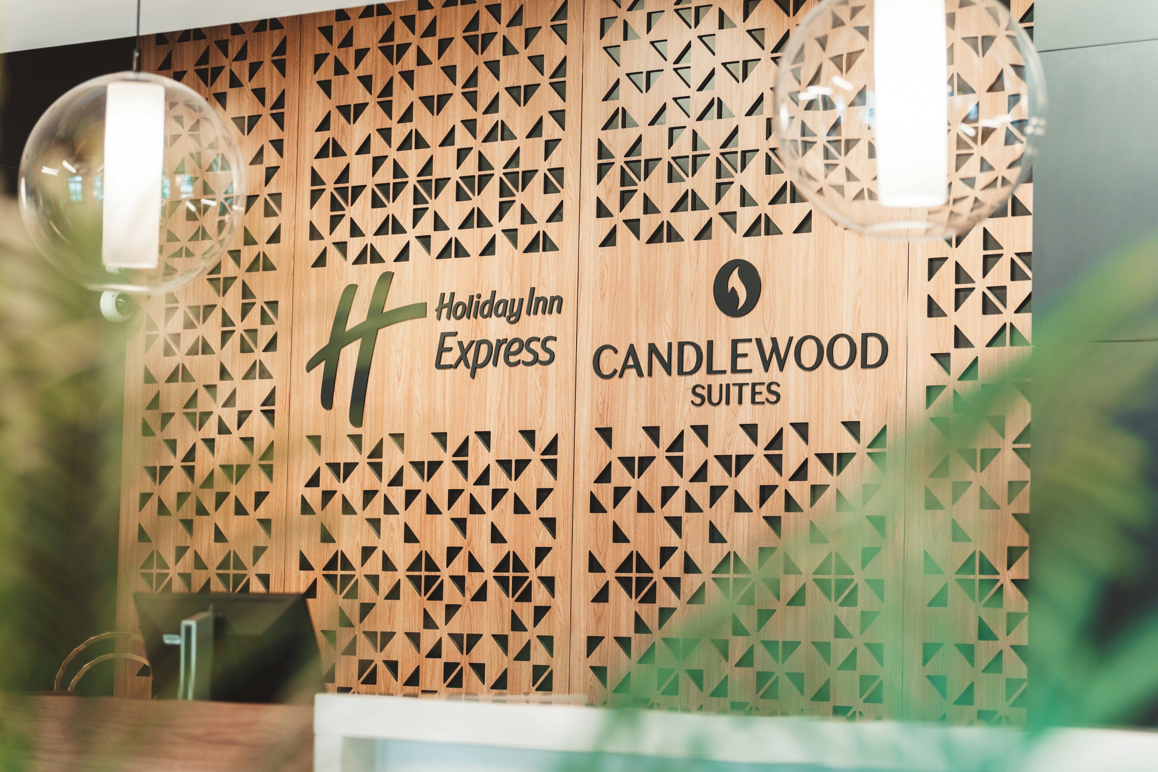 A Holiday Inn Express sign with a geometric pattern on the wall.