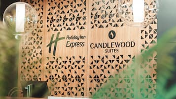 A Holiday Inn Express sign with a geometric pattern on the wall.