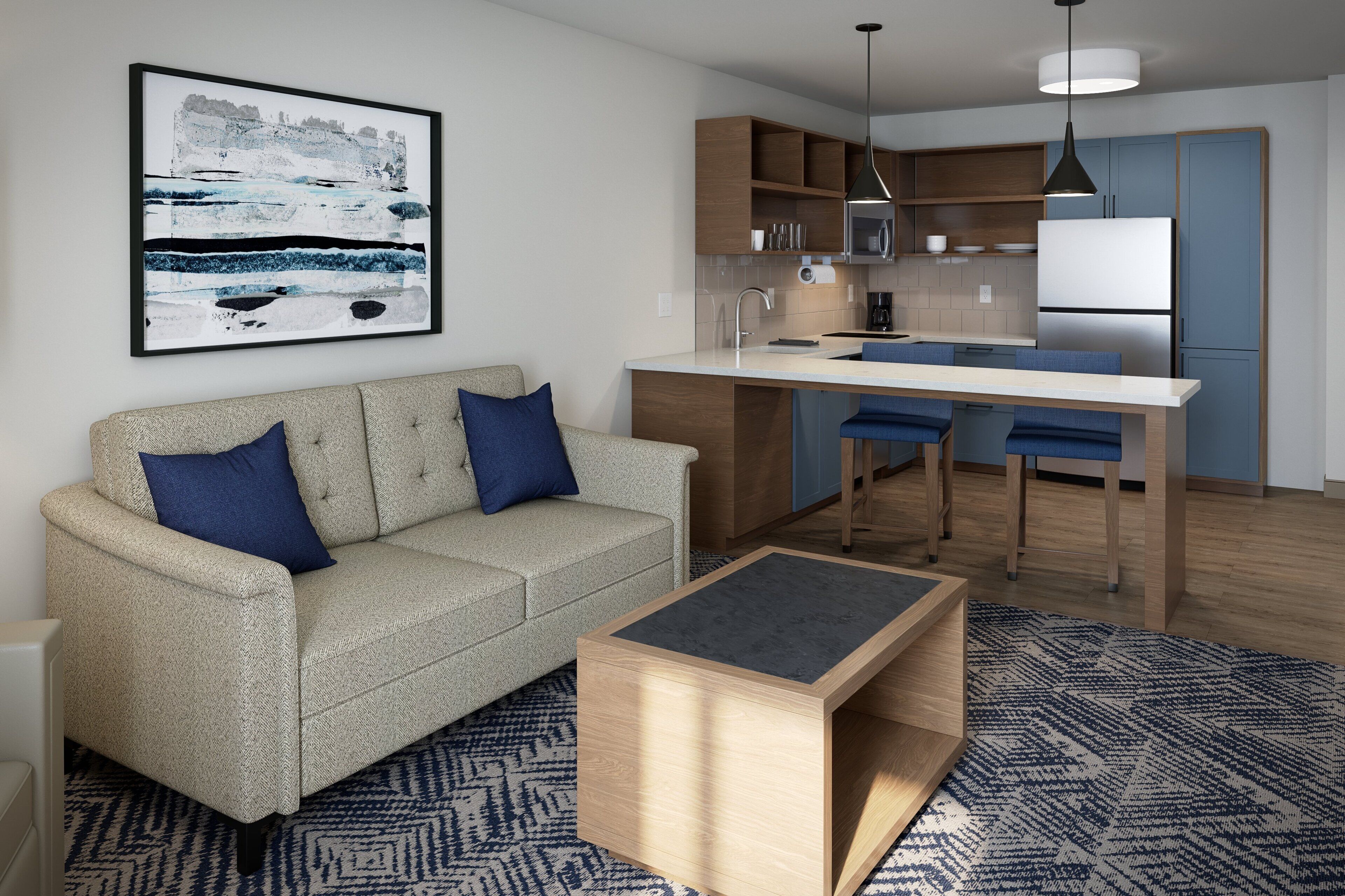 Una sala de estar moderna con un sofá, una mesa de centro y una zona de cocina con barra.