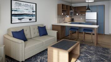 Una sala de estar moderna con un sofá, una mesa de centro y una zona de cocina con barra.