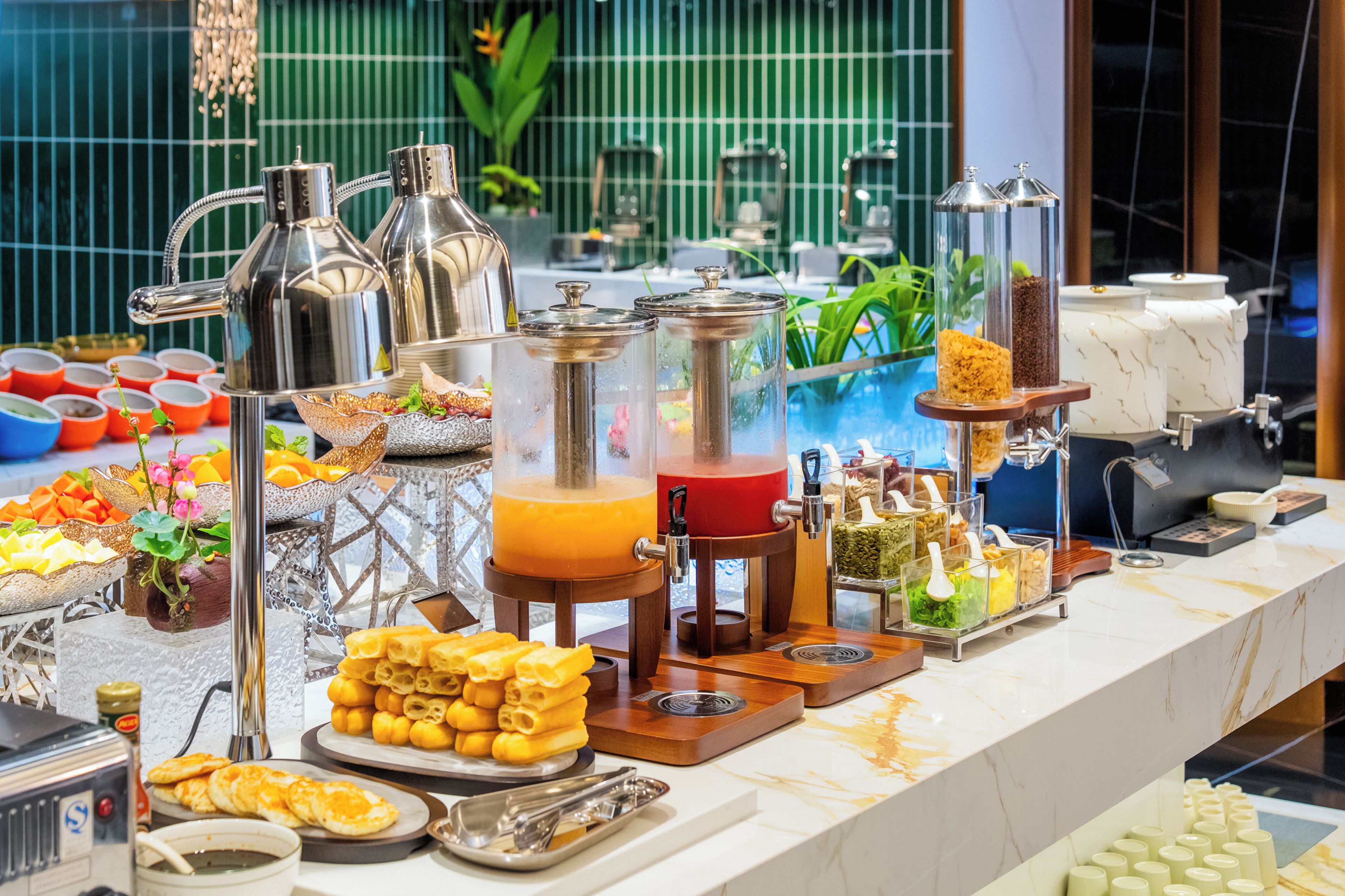 A buffet with various food items and beverages.