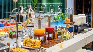 A buffet with various food items and beverages.