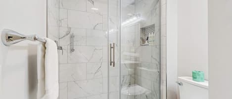 Chuveiro, toalhas de banho, shampoo