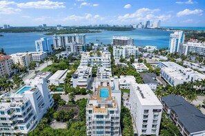 A high-rise residential area with multiple buildings, a swimming pool, and a view of the coastline. - Luxury Family 3BR Apt in Bay Harbor Islands near Beach, Shops and Dining Area (Bay Harbor Islands)