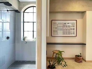 A bathroom with white tiles, a window, and a shower. - PENTHOUSE with great view (Guadalajara)