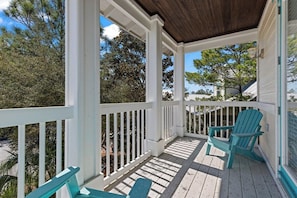 A covered porch with white railings and two turquoise Adirondack chairs. - “A Little Salt Therapy” in Cassine Village - Seagrove Beach - 3 BR / 3 BA - 2 Pools! (Santa Rosa Beach)