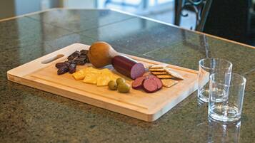 A wooden cutting board with various food items on a kitchen counter.