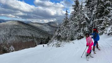 A snowy mountain landscape with skiers.