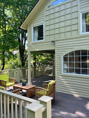 A covered deck with outdoor furniture, a pergola, and a view of a house with a large window. - Charming Victorian - Walk to Litchfield Green (Litchfield)